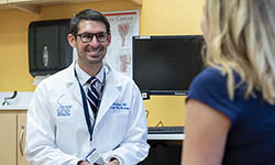 Dr. Evan Graboyes talks with a patient